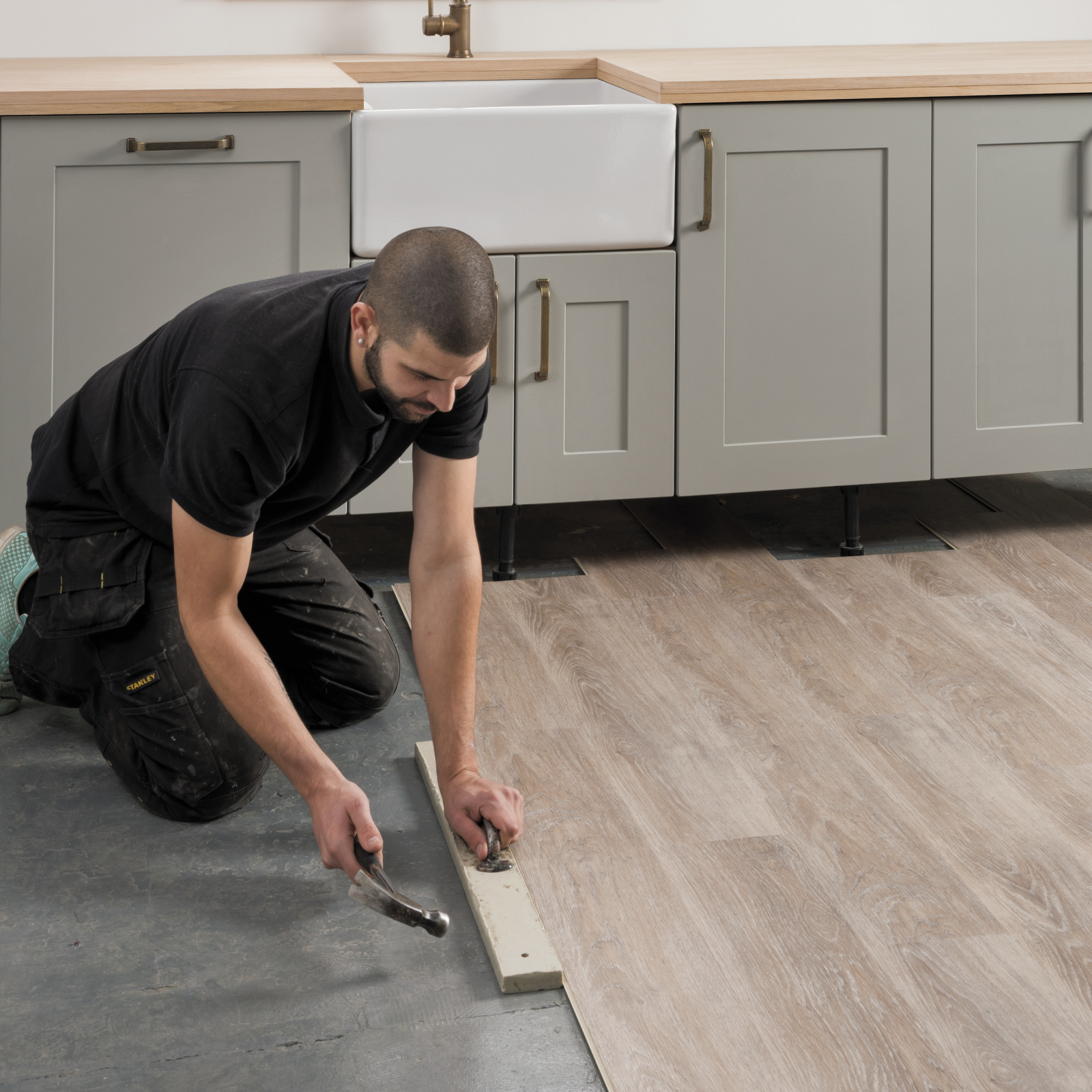 Professional installing Limed Coastal Oak rigid core lvp in a kitchen