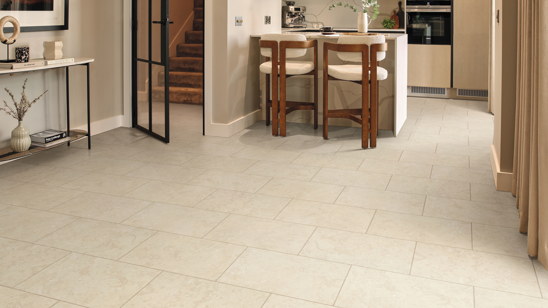 Natural Limestone gluedown lvt floors in a modern, neutral kitchen
