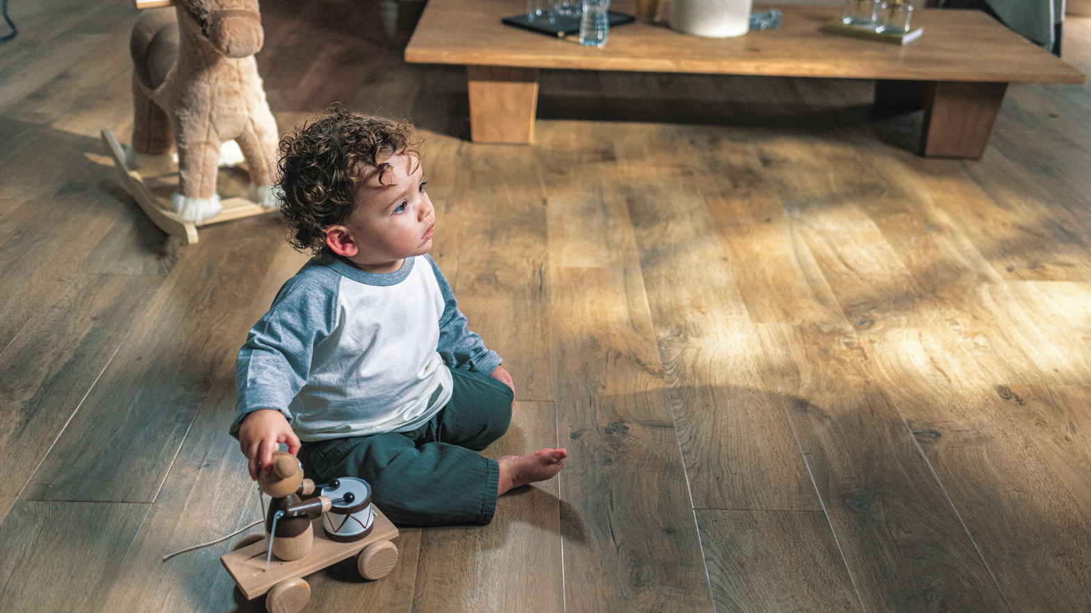 Karndean Designflooring Salon Oak lvt wood flooring in a living room and a boy playing