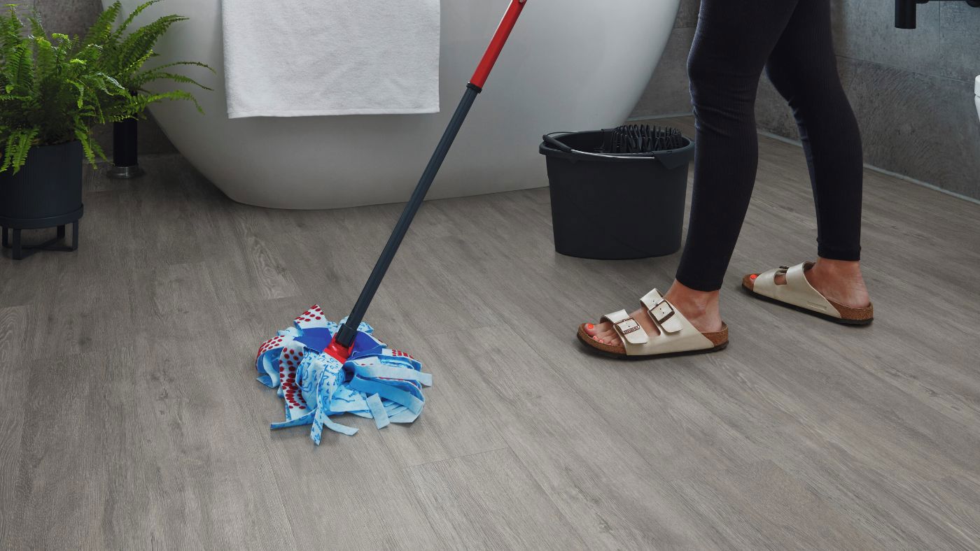 Easy maintenance grey vinyl flooring being mopped 