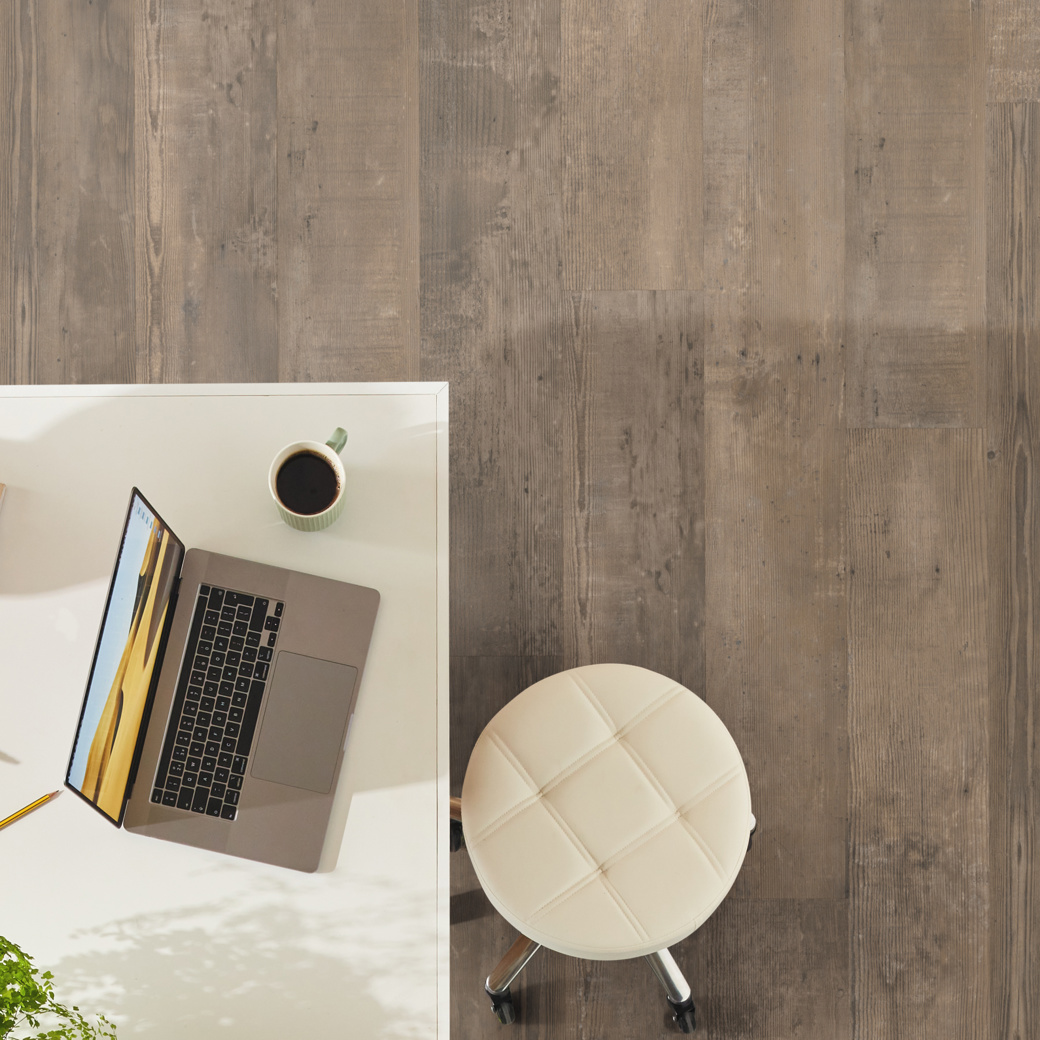 Overhead of a workspace with Smoked School Cedar lvp floors; available in gluedown and rigid core
